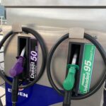 Fuel pump showing diesel and unleaded petrol nozzles with price displayed at R28.40 per litre.